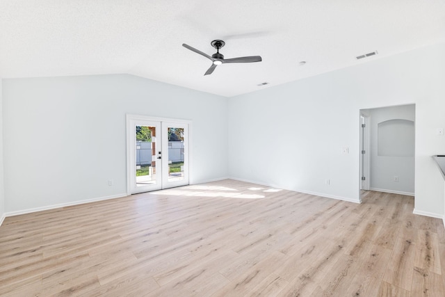 unfurnished room featuring lofted ceiling, ceiling fan, light hardwood / wood-style flooring, and french doors