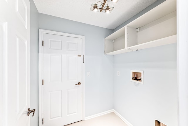 clothes washing area with washer hookup and a textured ceiling