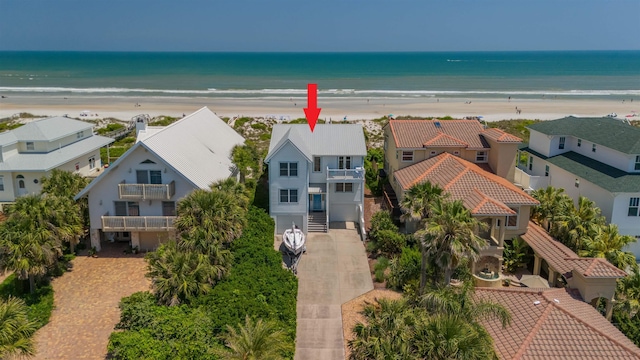 aerial view with a water view and a view of the beach