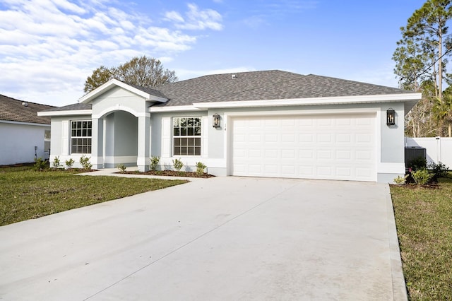 ranch-style home featuring a garage and a front lawn