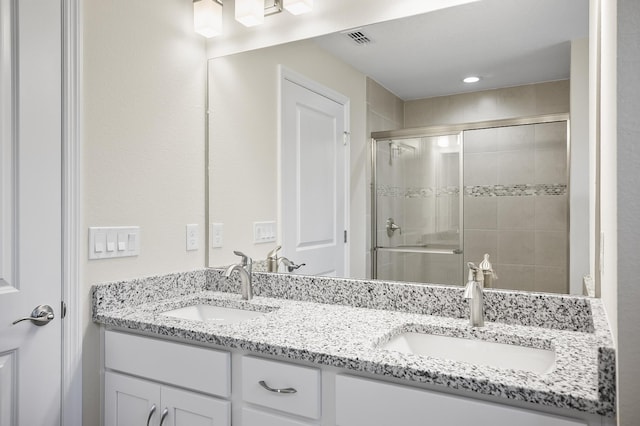 bathroom featuring walk in shower and vanity