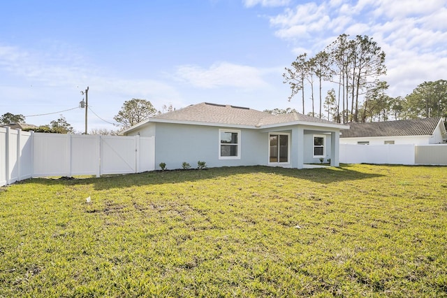 back of property featuring a lawn