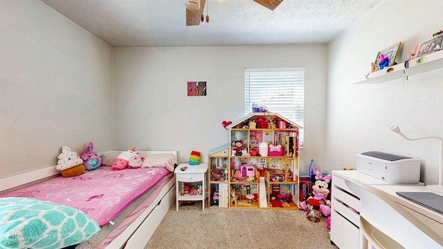 carpeted bedroom with ceiling fan and a textured ceiling