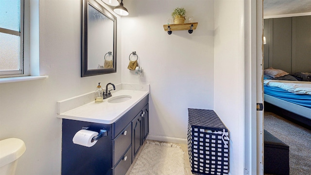 ensuite bathroom featuring vanity, baseboards, and ensuite bathroom