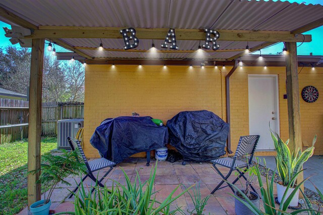 view of patio / terrace featuring a storage shed, an outdoor structure, and fence