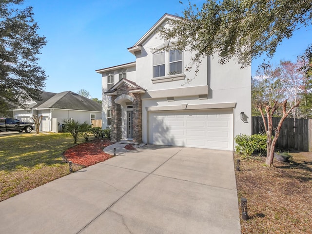 traditional home with stucco siding, fence, a garage, stone siding, and driveway