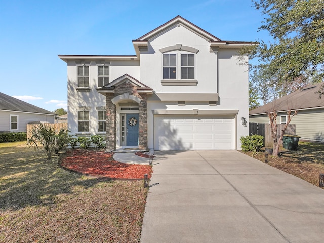 view of front of property with stucco siding, fence, a garage, stone siding, and driveway