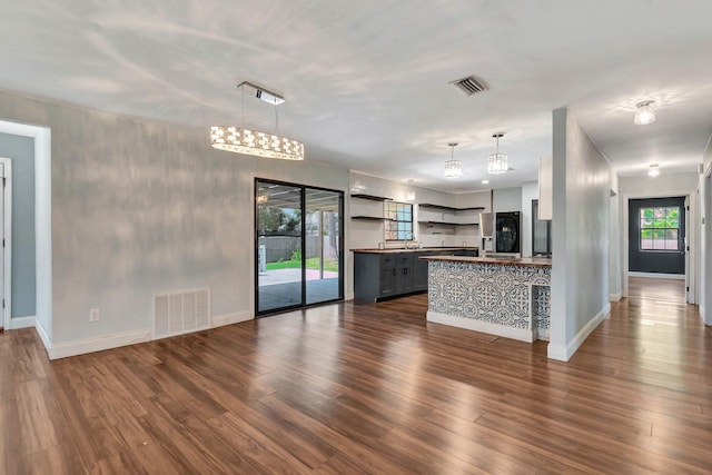 132 Southwind Cir, Saint Augustine, FL 32080 - unfurnished living room featuring dark wood-type flooring