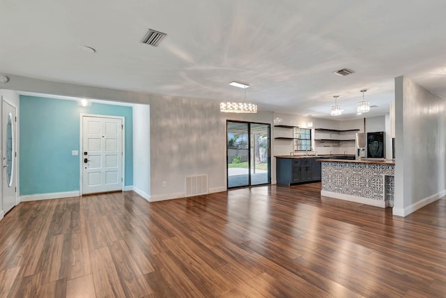 132 Southwind Cir, Saint Augustine, FL 32080 - unfurnished living room with dark wood-style flooring and baseboards