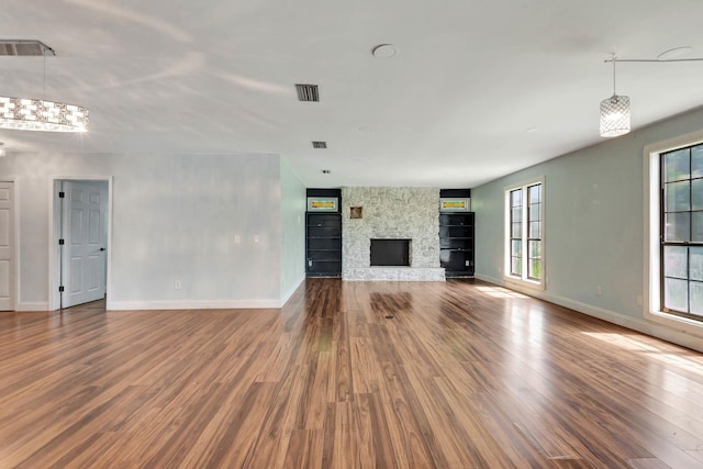 132 Southwind Cir, Saint Augustine, FL 32080 - unfurnished living room featuring wood finished floors, built in shelves, and a fireplace