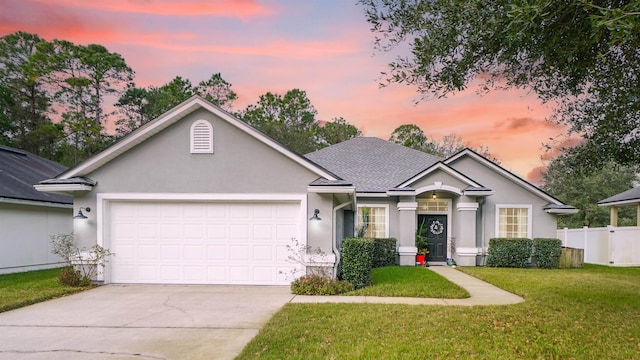 single story home with a yard and a garage