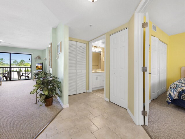 4250 A1A S L25, Saint Augustine, FL 32080 - corridor featuring light colored carpet, a sink, and baseboards