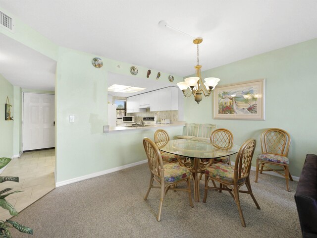 4250 A1A S L25, Saint Augustine, FL 32080 - dining room with a chandelier, baseboards, and light carpet