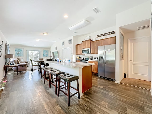 348 Ashby Landing Way, Saint Augustine, FL 32086 - kitchen featuring stainless steel appliances, dark wood-style floors, a kitchen breakfast bar, light countertops, and recessed lighting