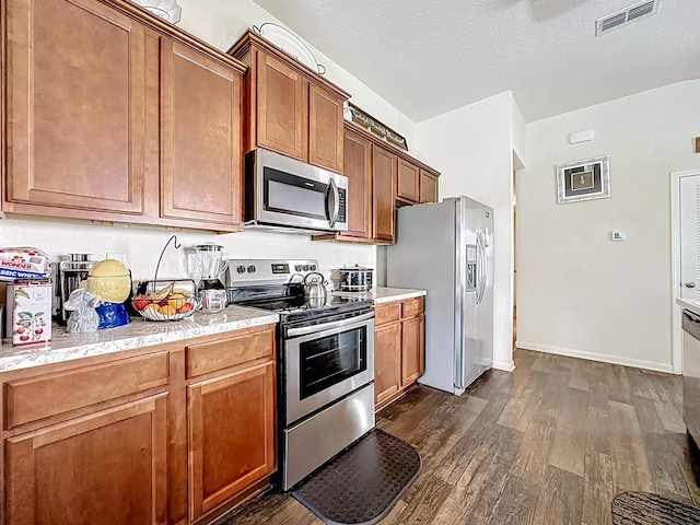 348 Ashby Landing Way, Saint Augustine, FL 32086 - kitchen featuring appliances with stainless steel finishes, dark wood finished floors, and brown cabinetry
