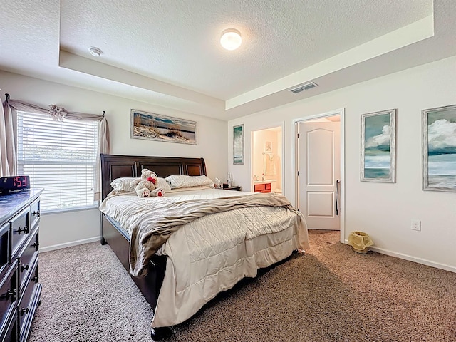 348 Ashby Landing Way, Saint Augustine, FL 32086 - bedroom with a textured ceiling, light carpet, a tray ceiling, and ensuite bathroom