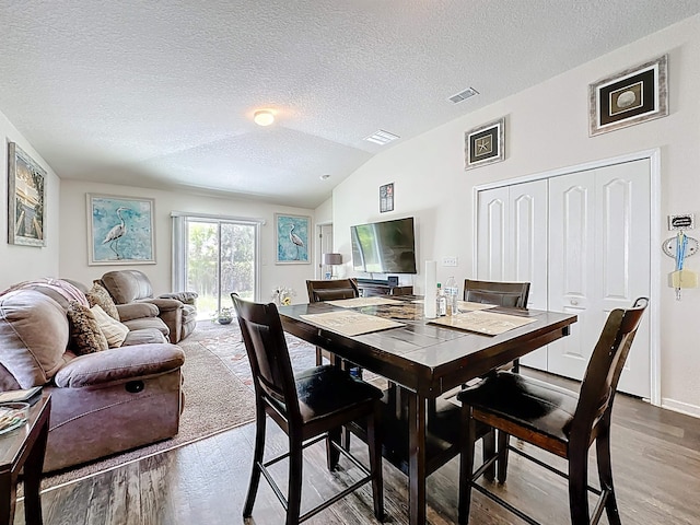 348 Ashby Landing Way, Saint Augustine, FL 32086 - dining area featuring light wood-style flooring, lofted ceiling, and a textured ceiling