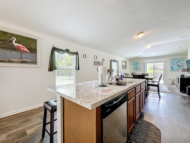 348 Ashby Landing Way, Saint Augustine, FL 32086 - kitchen with dishwasher, dark wood-style floors, light countertops, a center island with sink, and a textured ceiling