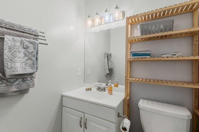 half bathroom featuring toilet and vanity