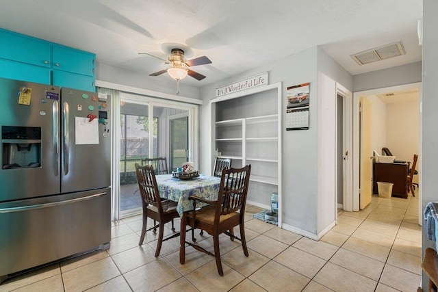 dining room featuring a ceiling fan, light tile patterned floors, and baseboards