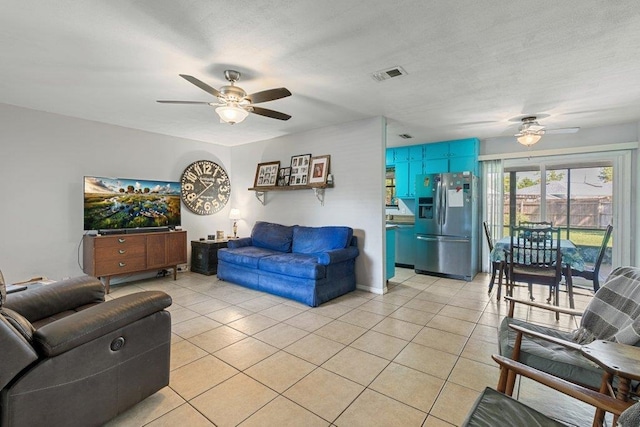living room featuring a ceiling fan and light tile patterned floors