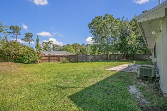 view of yard featuring central air condition unit and a patio area