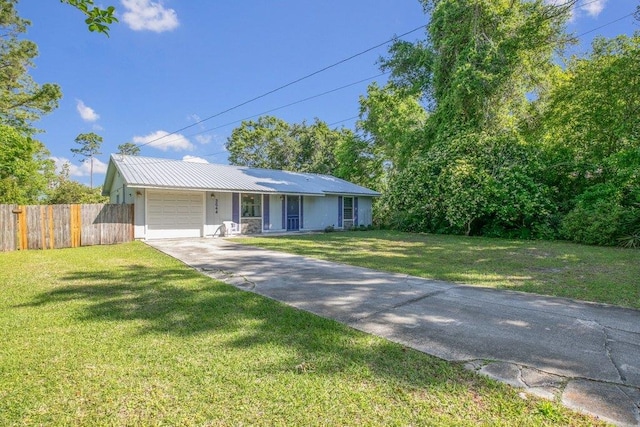 single story home featuring concrete driveway, a garage, and metal roof