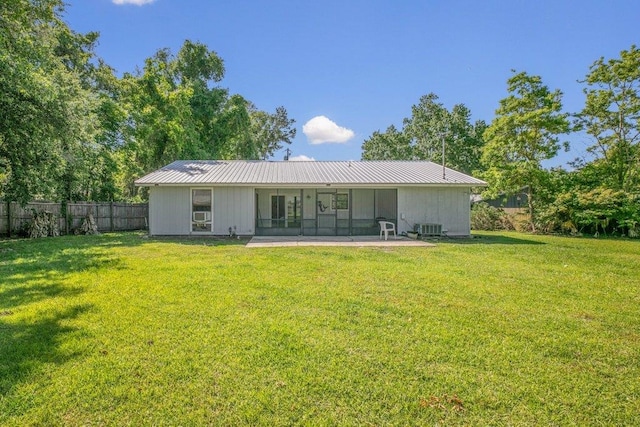 rear view of house featuring central AC, metal roof, a sunroom, and a patio area