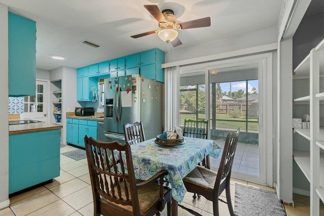 dining area featuring light tile patterned floors and a ceiling fan