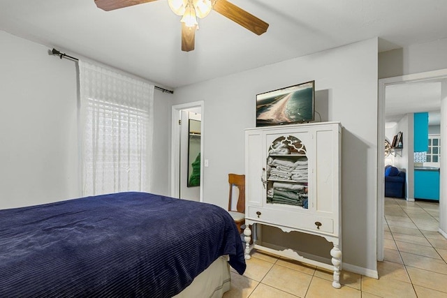 bedroom featuring light tile patterned floors and ceiling fan