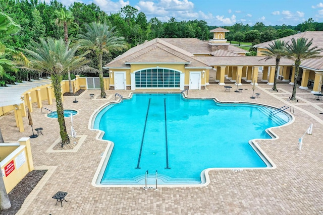 501 Olympic Cir, Saint Augustine, FL 32092 - community pool with a patio and view of wooded area