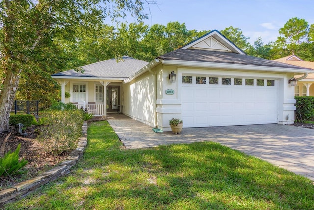 501 Olympic Cir, Saint Augustine, FL 32092 - ranch-style house with an attached garage, driveway, covered porch, roof with shingles, and stucco siding