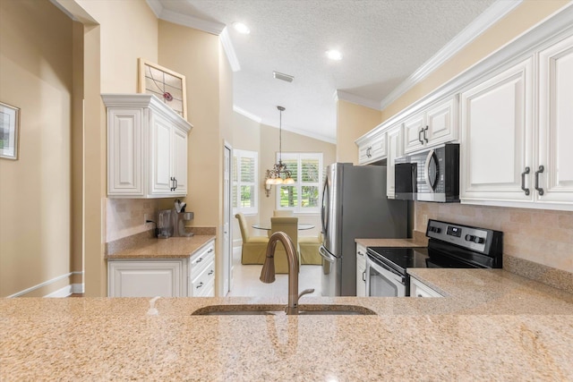 501 Olympic Cir, Saint Augustine, FL 32092 - kitchen with appliances with stainless steel finishes, ornamental molding, a textured ceiling, tasteful backsplash, and white cabinetry