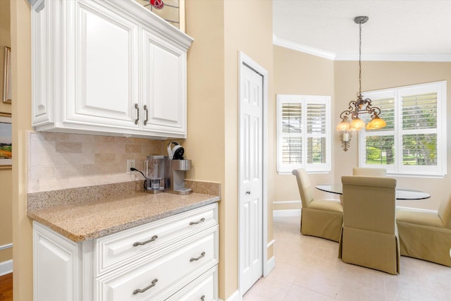 501 Olympic Cir, Saint Augustine, FL 32092 - kitchen featuring backsplash, ornamental molding, light tile patterned floors, white cabinetry, and a chandelier