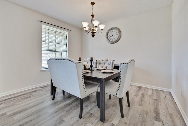 dining area featuring a chandelier and light hardwood / wood-style flooring