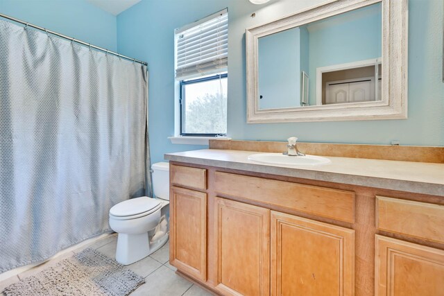 bathroom with vanity, tile patterned floors, toilet, and a shower with shower curtain