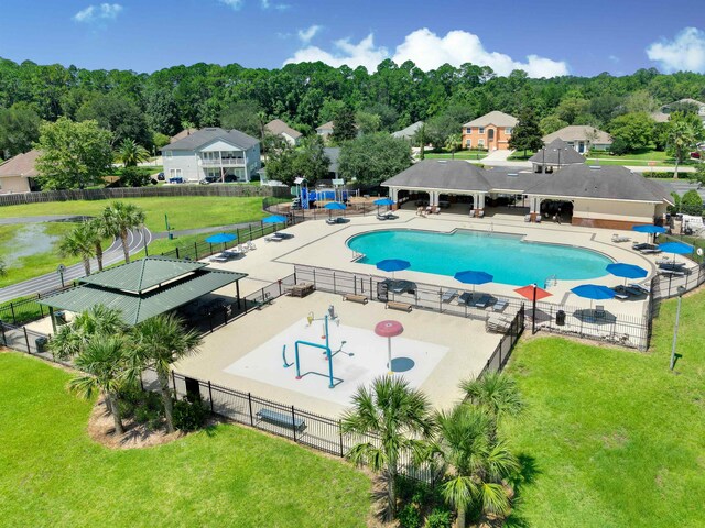 view of swimming pool featuring a patio area and a lawn