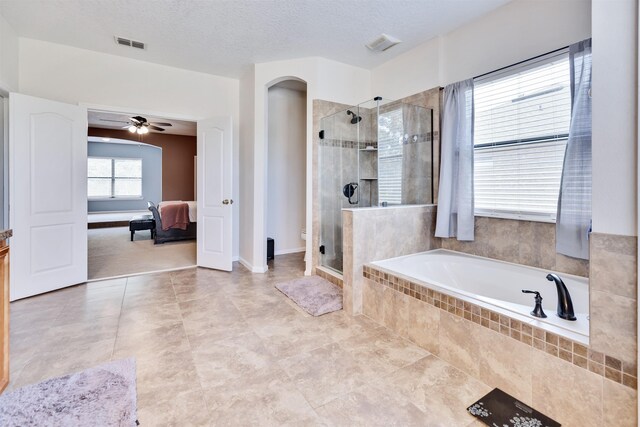 bathroom featuring separate shower and tub, a textured ceiling, and ceiling fan