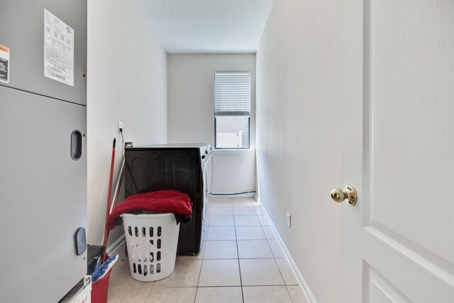 bedroom featuring washing machine and clothes dryer and light tile patterned flooring