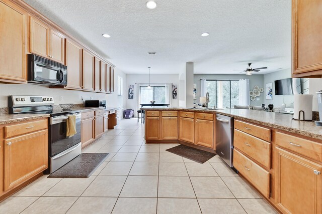 kitchen with pendant lighting, appliances with stainless steel finishes, a textured ceiling, light tile patterned flooring, and kitchen peninsula