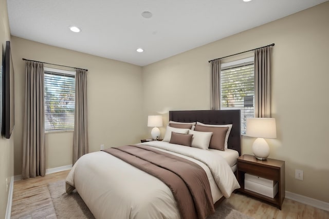 bedroom featuring light wood-type flooring and multiple windows