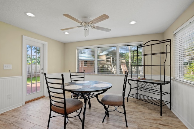 dining space with plenty of natural light, ceiling fan, and light wood-type flooring