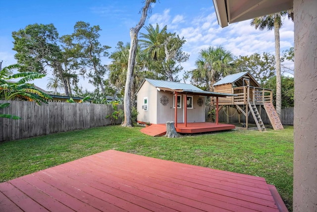 wooden terrace with a yard and an outdoor structure