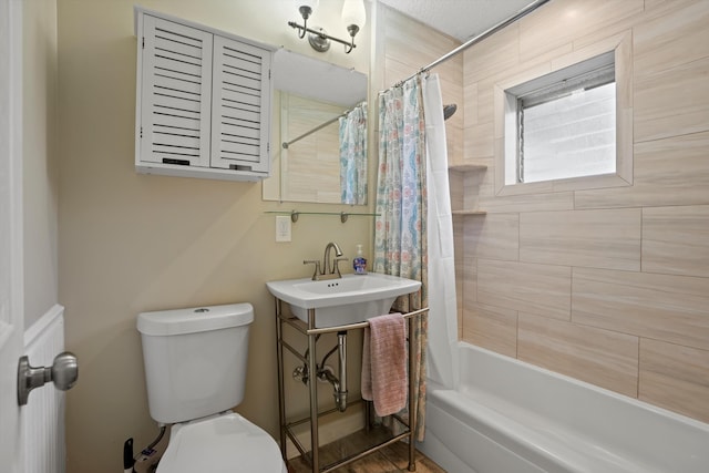 full bathroom with shower / bath combo, toilet, and sink