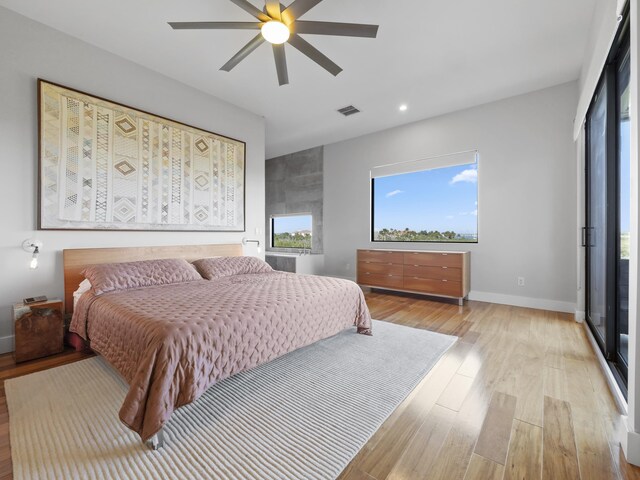 bedroom with ceiling fan and light hardwood / wood-style floors