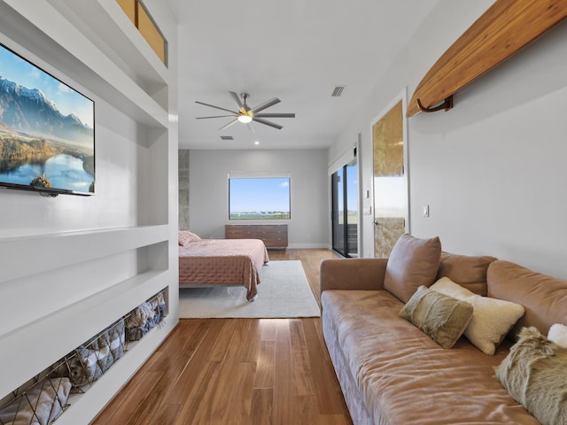 bedroom with access to exterior, wood-type flooring, and ceiling fan