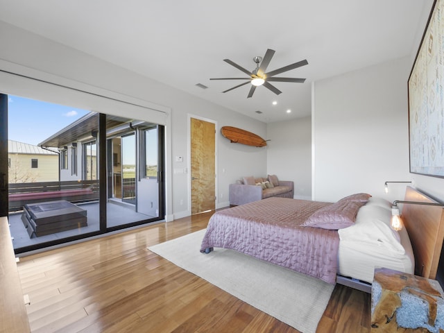 bedroom with access to outside, ceiling fan, and hardwood / wood-style flooring