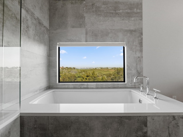 bathroom featuring a relaxing tiled tub