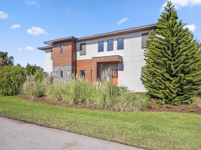 contemporary home featuring a front lawn