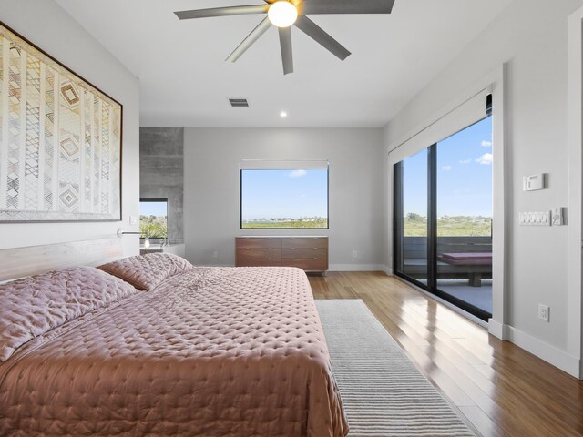 bedroom featuring access to exterior, hardwood / wood-style floors, and ceiling fan